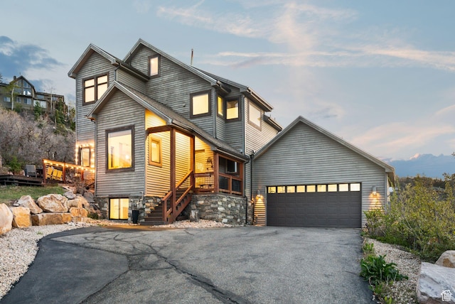 7515 Stagecoach Dr, Park City, UT 84098 - modern home featuring asphalt driveway, stairway, and a garage