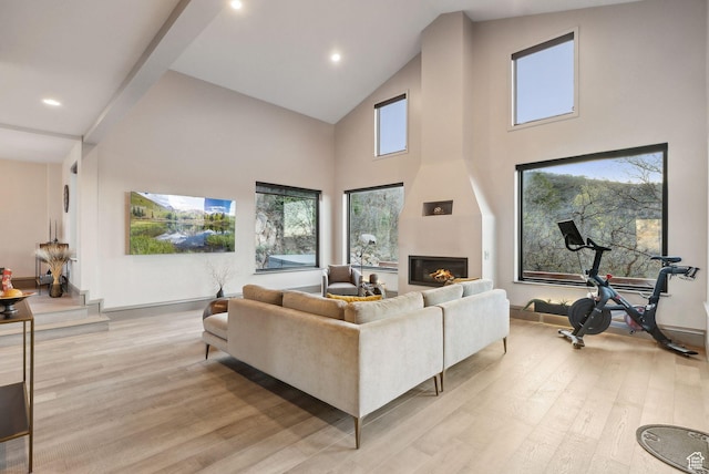 7515 Stagecoach Dr, Park City, UT 84098 - living room with light wood-type flooring, high vaulted ceiling, healthy amount of natural light, a fireplace, and recessed lighting