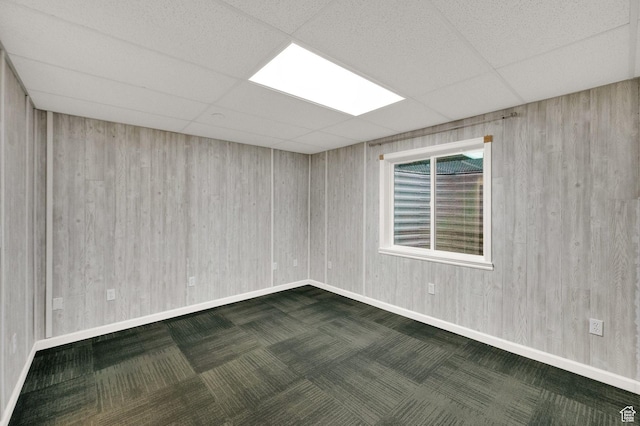 10557 S Pipestone Way S, Jordan, UT 84009 - empty room with a paneled ceiling, dark carpet, baseboards, and wooden walls