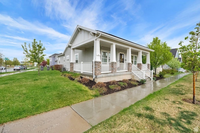 10557 S Pipestone Way S, Jordan, UT 84009 - bungalow-style home with board and batten siding, a front yard, covered porch, central AC unit, and stone siding