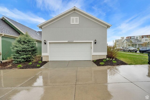 10557 S Pipestone Way S, Jordan, UT 84009 - view of side of property with concrete driveway and stucco siding