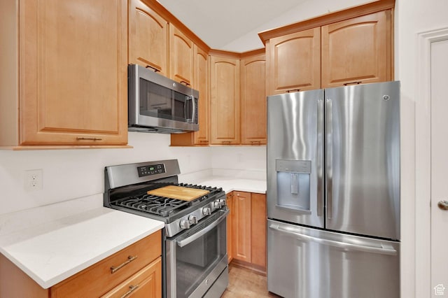 10557 S Pipestone Way S, Jordan, UT 84009 - kitchen with light brown cabinets, light countertops, appliances with stainless steel finishes, and vaulted ceiling