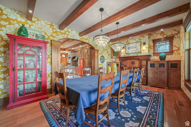 1608 W 1970 N, Provo, UT 84604 - dining area with wallpapered walls, arched walkways, wood finished floors, beamed ceiling, and a chandelier