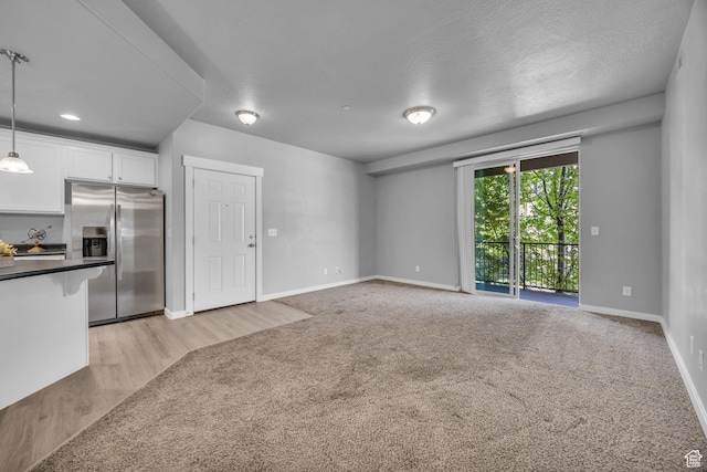 282 W 605 N Unit 307, Centerville, UT 84014 - unfurnished living room featuring baseboards, light carpet, and light wood-style floors