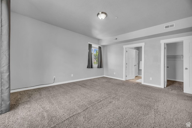 282 W 605 N Unit 307, Centerville, UT 84014 - unfurnished bedroom featuring baseboards, a spacious closet, carpet flooring, and visible vents