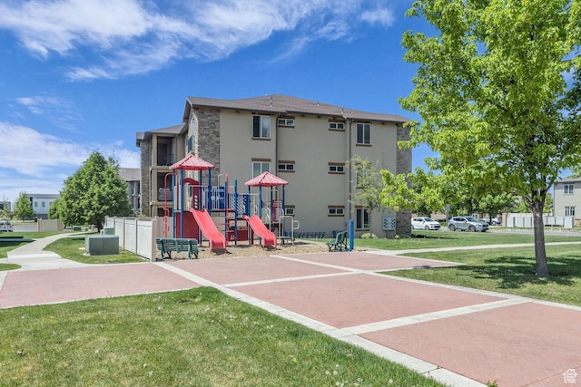 282 W 605 N Unit 307, Centerville, UT 84014 - exterior space with playground community, stucco siding, stone siding, and a yard