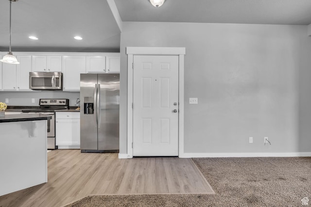 282 W 605 N Unit 307, Centerville, UT 84014 - kitchen with dark countertops, appliances with stainless steel finishes, baseboards, and white cabinetry