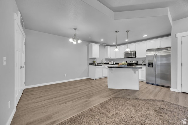 282 W 605 N Unit 307, Centerville, UT 84014 - kitchen with baseboards, light wood finished floors, white cabinetry, dark countertops, and appliances with stainless steel finishes