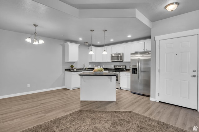 282 W 605 N Unit 307, Centerville, UT 84014 - kitchen with a sink, dark countertops, light wood-type flooring, baseboards, and appliances with stainless steel finishes