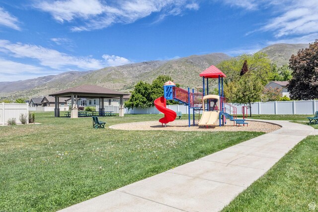 282 W 605 N Unit 307, Centerville, UT 84014 - community jungle gym featuring a yard, a mountain view, and fence