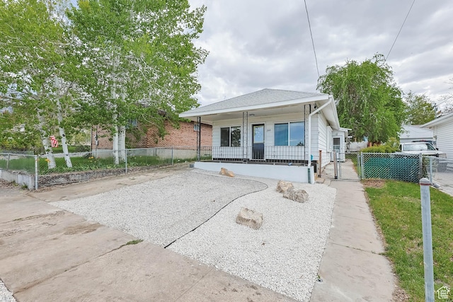 bungalow-style house featuring a porch, a gate, and fence