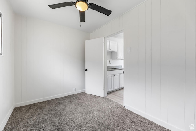 390 E Vine, Tooele, UT 84074 - unfurnished bedroom featuring a ceiling fan, a sink, baseboards, ensuite bath, and light carpet