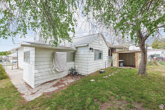 390 E Vine, Tooele, UT 84074 - rear view of house with a storage shed, a yard, an outdoor structure, and fence