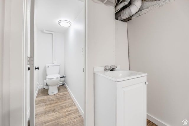 390 E Vine, Tooele, UT 84074 - half bath with toilet, baseboards, vanity, and wood finished floors