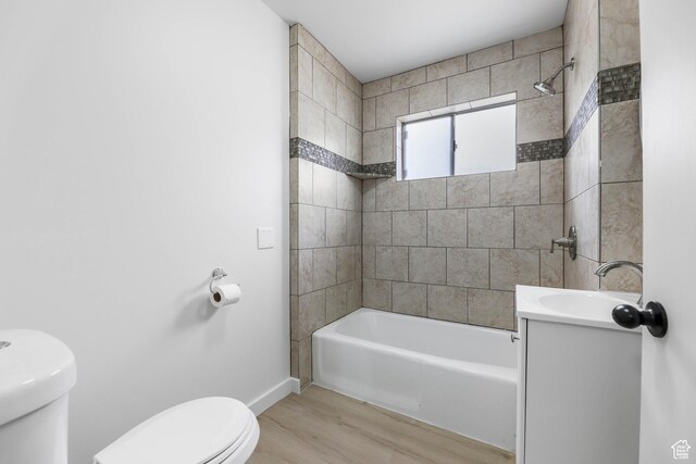 390 E Vine, Tooele, UT 84074 - bathroom featuring toilet, wood finished floors, vanity, baseboards, and bathtub / shower combination