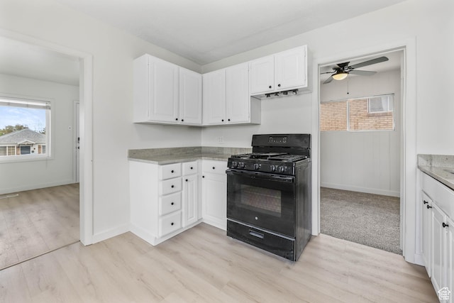 390 E Vine, Tooele, UT 84074 - kitchen featuring light wood-style flooring, a ceiling fan, white cabinetry, baseboards, and black gas stove