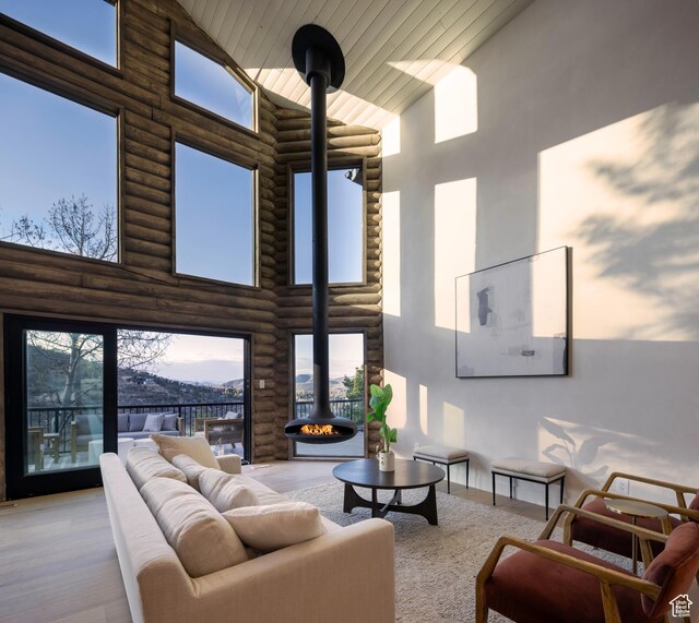 7370 N Buckboard Dr, Park City, UT 84098 - living room featuring wood finished floors, a wood stove, high vaulted ceiling, log walls, and wooden ceiling
