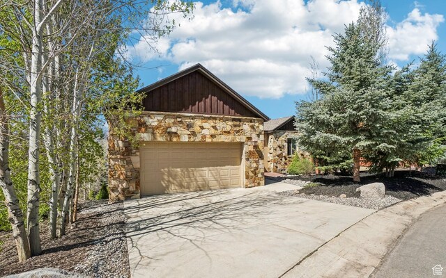 12221 Ross Creek Dr Unit 137, Kamas, UT 84036 - exterior space featuring concrete driveway, stone siding, a garage, and board and batten siding