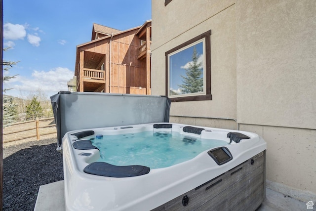 12221 Ross Creek Dr Unit 137, Kamas, UT 84036 - exterior space featuring stucco siding, a hot tub, and fence