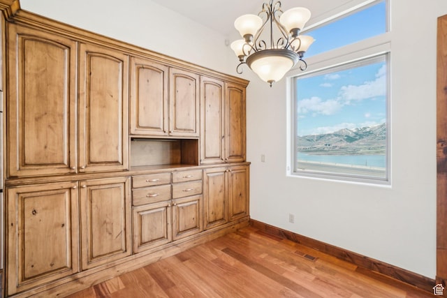 12221 Ross Creek Dr Unit 137, Kamas, UT 84036 - unfurnished dining area featuring baseboards, visible vents, an inviting chandelier, and light wood-type flooring