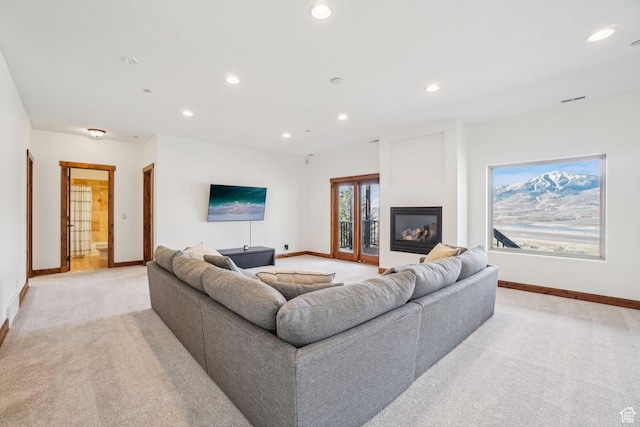 12221 Ross Creek Dr Unit 137, Kamas, UT 84036 - living room with light colored carpet, baseboards, a glass covered fireplace, and recessed lighting