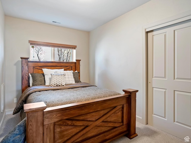 carpeted bedroom featuring visible vents and baseboards