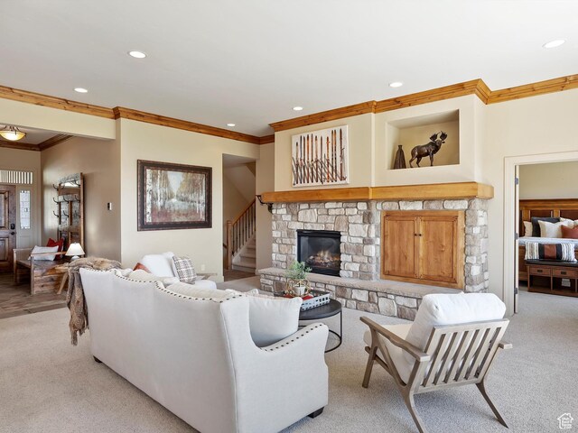 living area featuring a fireplace, crown molding, light carpet, and recessed lighting