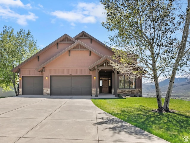 craftsman inspired home with stone siding, board and batten siding, driveway, and a garage