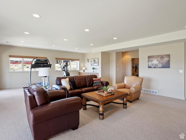 living room featuring recessed lighting, visible vents, and light carpet