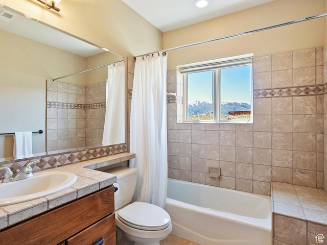 full bathroom featuring toilet, shower / tub combo, visible vents, and vanity