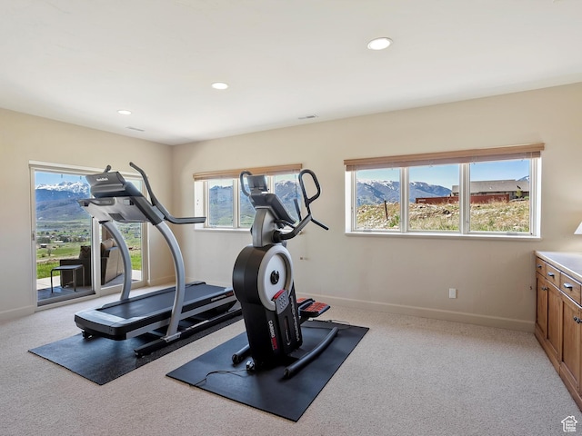 exercise room with light colored carpet, baseboards, and recessed lighting