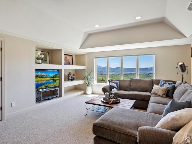 carpeted living room with baseboards, a tray ceiling, recessed lighting, and built in features
