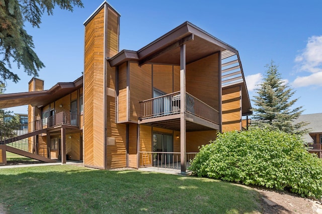 2025 Canyons Resort Dr Unit D4, Park City, UT 84098 - rear view of property with a chimney, a balcony, a yard, and stairs