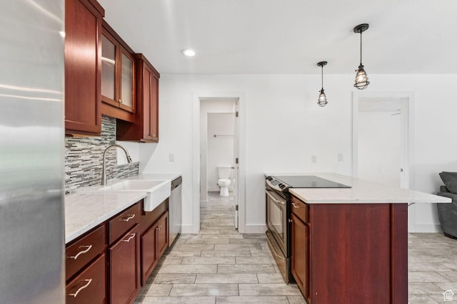 2025 Canyons Resort Dr Unit D4, Park City, UT 84098 - kitchen with stainless steel appliances, tasteful backsplash, glass insert cabinets, decorative light fixtures, and light stone counters