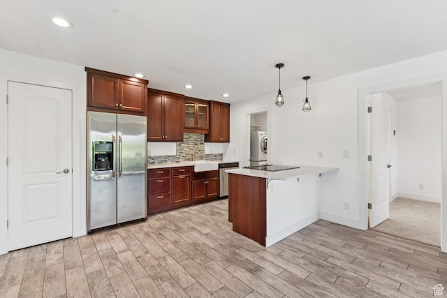 2025 Canyons Resort Dr Unit D4, Park City, UT 84098 - kitchen with stainless steel appliances, a peninsula, light wood-type flooring, glass insert cabinets, and light countertops