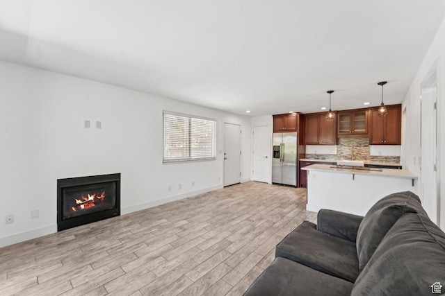 2025 Canyons Resort Dr Unit D4, Park City, UT 84098 - living room featuring light wood finished floors, recessed lighting, and a warm lit fireplace