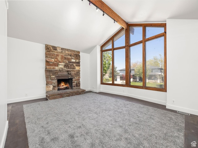 unfurnished living room with a fireplace, lofted ceiling with beams, visible vents, dark wood-style flooring, and baseboards