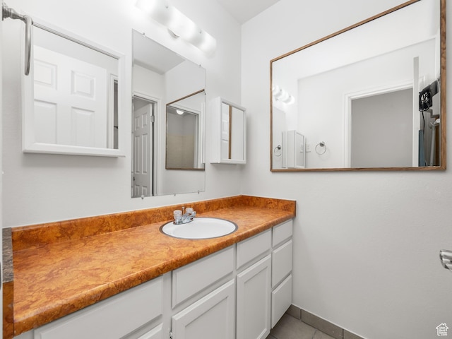bathroom featuring tile patterned flooring and vanity