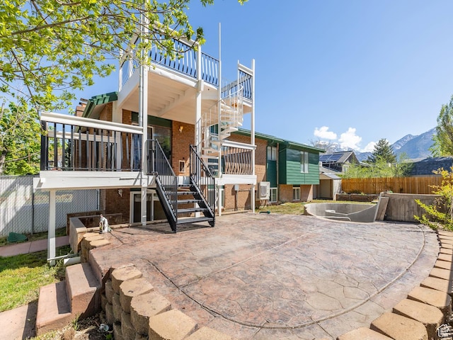 back of house with a patio area, stairway, brick siding, and fence