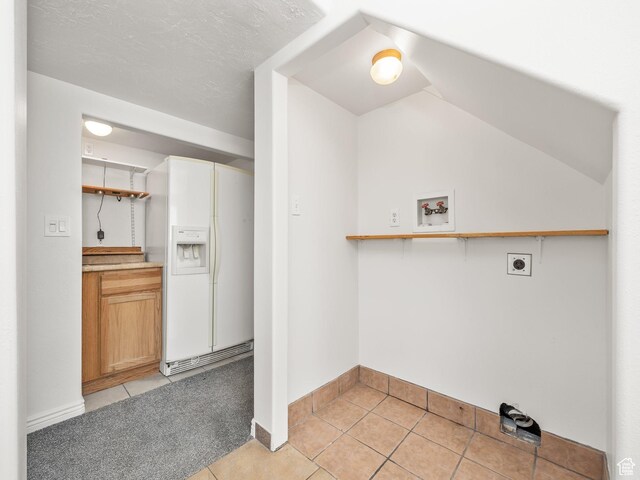 washroom featuring baseboards, light tile patterned flooring, hookup for an electric dryer, and hookup for a washing machine