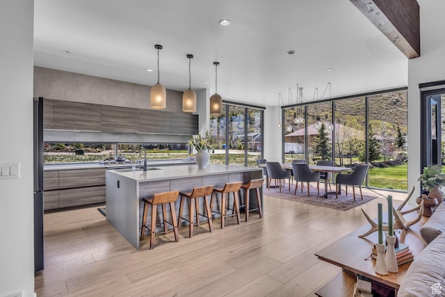 846 E 270 S, Kamas, UT 84036 - kitchen featuring modern cabinets, a breakfast bar area, light countertops, light wood-style flooring, and recessed lighting