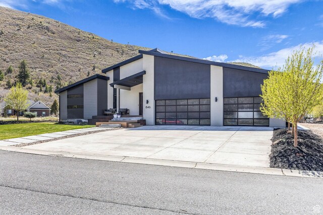 846 E 270 S, Kamas, UT 84036 - view of front of property featuring an attached garage, driveway, a mountain view, and stucco siding
