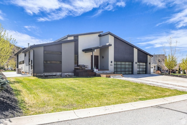 846 E 270 S, Kamas, UT 84036 - view of front of property featuring concrete driveway, a front yard, a garage, cooling unit, and stucco siding