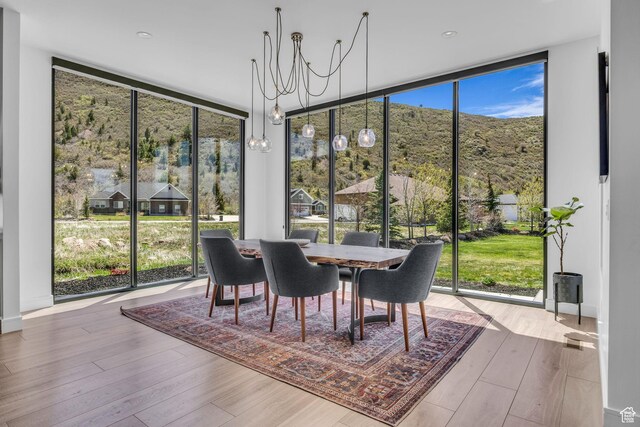 846 E 270 S, Kamas, UT 84036 - dining area featuring a wall of windows, healthy amount of natural light, wood finished floors, a chandelier, and a mountain view