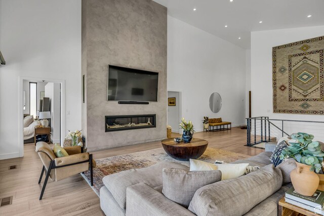 846 E 270 S, Kamas, UT 84036 - living room featuring a high ceiling, light wood-style flooring, a premium fireplace, recessed lighting, and baseboards