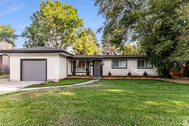 ranch-style home featuring covered porch, driveway, a garage, a front lawn, and a chimney