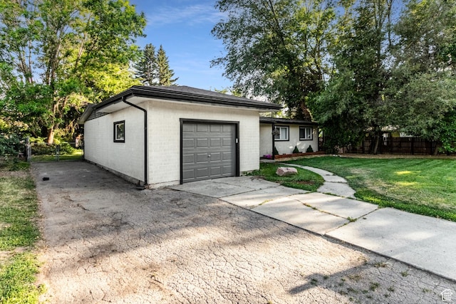 garage featuring fence and driveway