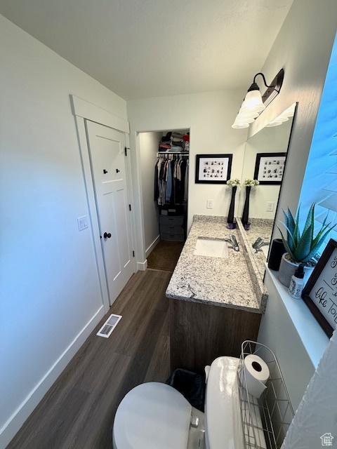 88 E 970 N, Santaquin, UT 84655 - bathroom featuring toilet, wood finished floors, visible vents, baseboards, and vanity