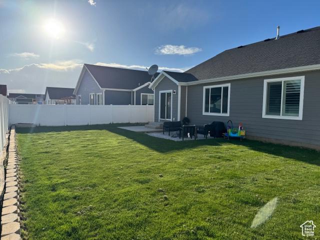 88 E 970 N, Santaquin, UT 84655 - back of house with a fenced backyard, a patio, and a lawn