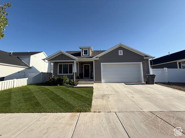 88 E 970 N, Santaquin, UT 84655 - craftsman house featuring concrete driveway, a front lawn, a garage, and fence